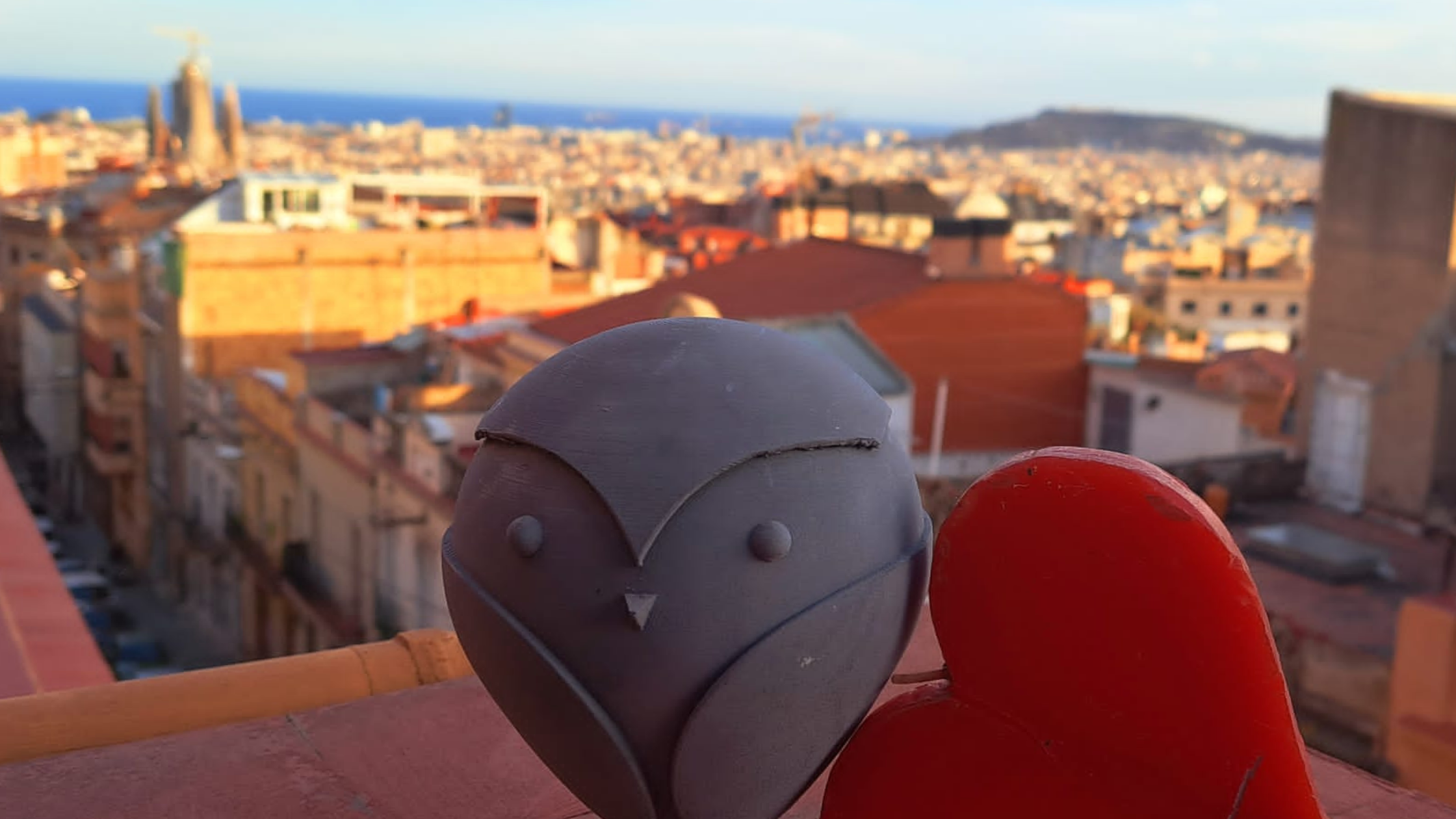 Bam with a red heart overlooking Barcelona with Sagrada Familia in the background.